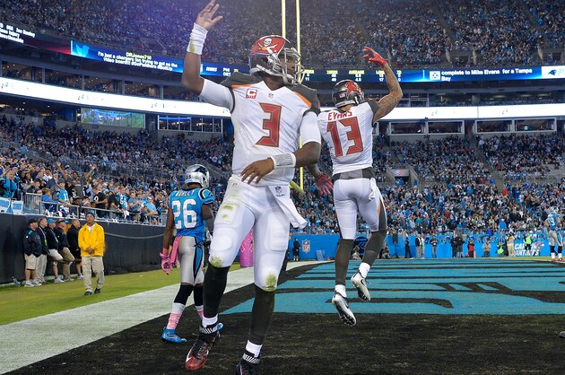 CHARLOTTE, NC - OCTOBER 10:  Jameis Winston #3 and teammate Mike Evans #13 of the Tampa Bay Buccaneers celebrate their 3rd quarter touchdown against the Carolina Panthers during the game at Bank of America Stadium on October 10, 2016 in Charlotte, North Carolina.  (Photo by Grant Halverson/Getty Images)