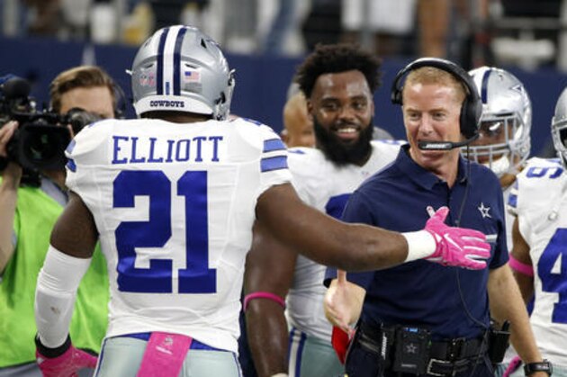Dallas Cowboys running back Ezekiel Elliott (21) celebrates his long touchdown run with head coach Jason Garrett, right, in the second half of an NFL football game against the Cincinnati Bengals on Sunday, Oct. 9, 2016, in Arlington, Texas. (AP Photo/Ron Jenkins)