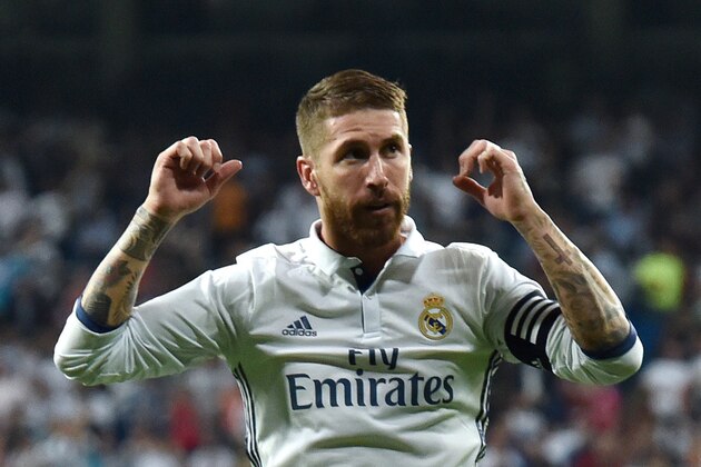 Real Madrid's defender Sergio Ramos celebrates a goal during the Spanish league football match Real Madrid CF vs Villarreal CF at the Santiago Bernabeu stadium in Madrid on September 21, 2016. / AFP / GERARD JULIEN        (Photo credit should read GERARD JULIEN/AFP/Getty Images)