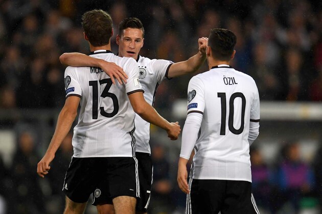 Germany's midfielder Julian Draxler (C) and his teammates celebrate after scoring 1-0 during the WC 2018 football qualification match between Germany and Northern Ireland in Hanover, Germany on October 11, 2016.  / AFP / Patrik STOLLARZ        (Photo credit should read PATRIK STOLLARZ/AFP/Getty Images)