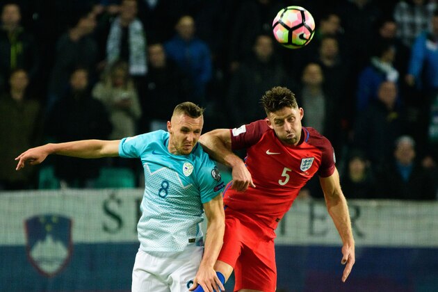 Slovenia's midfielder Jasmin Kurtic (L) vies for the ball with England's defender Gary Cahill (R) during the Fifa World Cup 2018 football qualification match between Slovenia and England in Ljubljana, on October 11, 2016. / AFP / Jure MAKOVEC        (Photo credit should read JURE MAKOVEC/AFP/Getty Images)