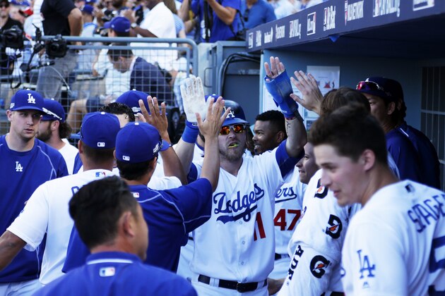LOS ANGELES, CA - OCTOBER 11:  Josh Reddick #11 celebrates with teammates in the duggout after scoring on a double by Joc Pederson #31 of the Los Angeles Dodgers in the fifth inning against the Washington Nationals during game four of the National League Division Series at Dodger Stadium on October 11, 2016 in Los Angeles, California.  (Photo by Jeff Gross/Getty Images)