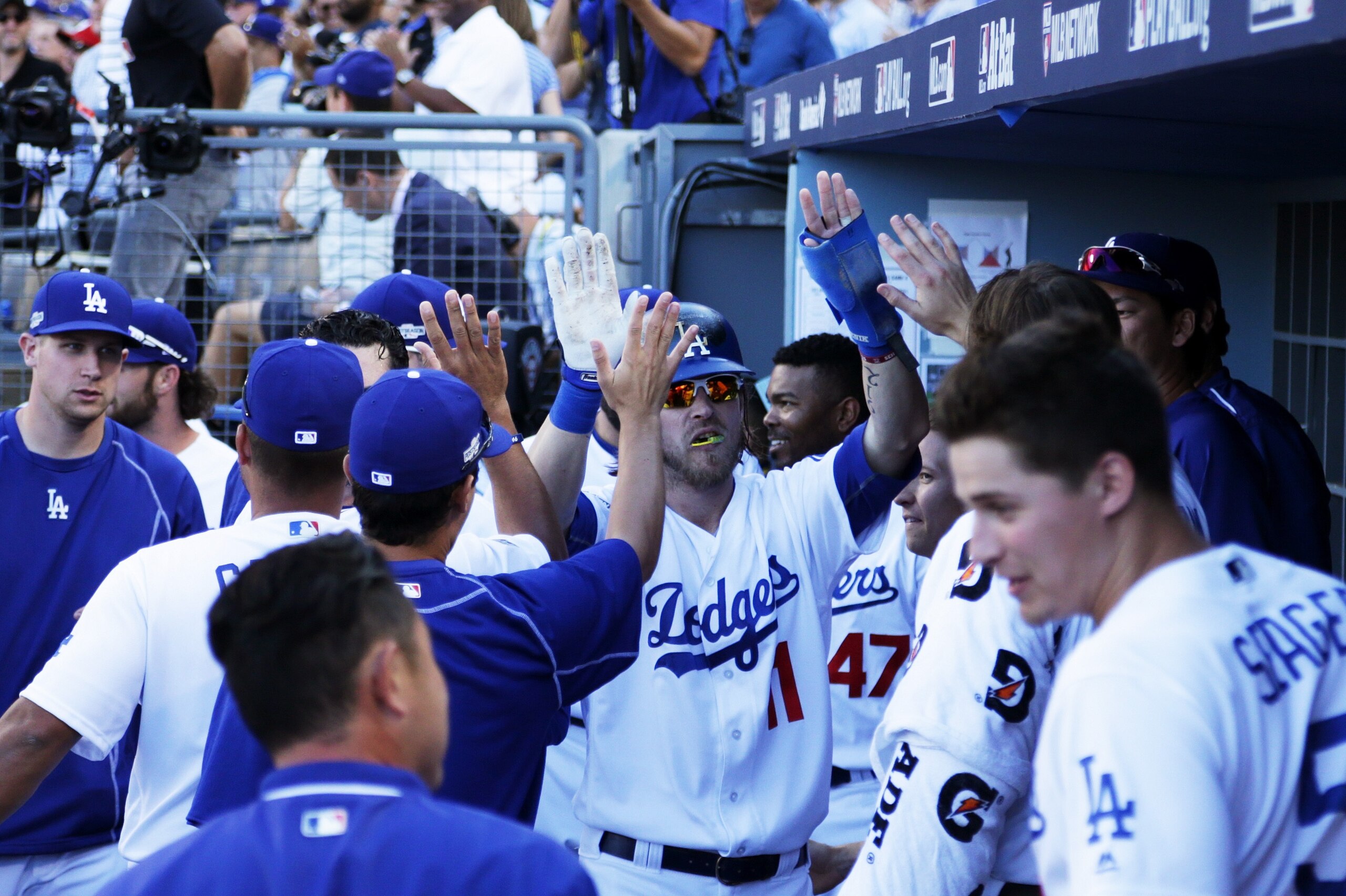 LOS ANGELES, CA - OCTOBER 11: Josh Reddick #11 celebrates with teammates in the duggout after scoring on a double by Joc Pederson #31 of the Los Angeles Dodgers in the fifth inning against the Washington Nationals during game four of the National League Division Series at Dodger Stadium on October 11, 2016 in Los Angeles, California. (Photo by Jeff Gross/Getty Images) LOS ANGELES, CA - OCTOBER 11: Josh Reddick #11 celebrates with teammates in the duggout after scoring on a double by Joc Pederson #31 of the Los Angeles Dodgers in the fifth inning against the Washington Nationals during game four of the National League Division Series at Dodger Stadium on October 11, 2016 in Los Angeles, California. (Photo by Jeff Gross/Getty Images)