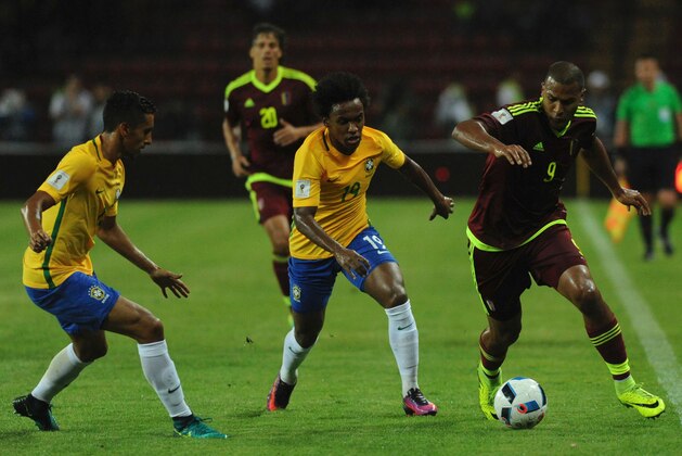 Brazil's Willian (C) vie for the ball with Venezuela's forward Salomon Rondon during their Russia 2018 World Cup football qualifier match in Merida, Venezuela, on October 11, 2016. / AFP / GEORGE CASTELLANOS        (Photo credit should read GEORGE CASTELLANOS/AFP/Getty Images)