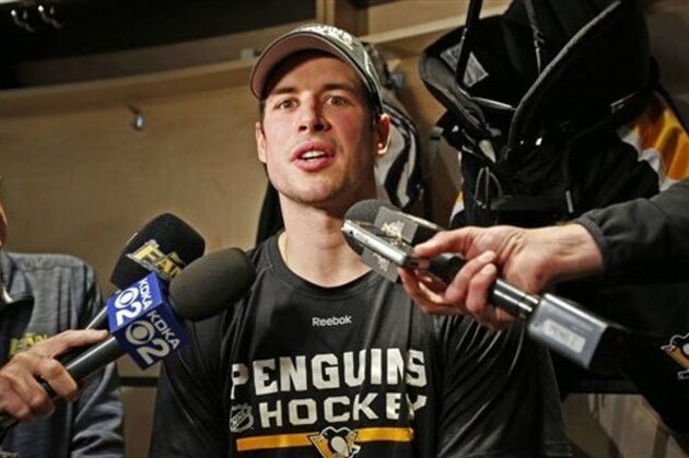 Pittsburgh Penguins' Sidney Crosby talks with reporters at his locker after skating at the Penguins' practice facility in Cranberry Township, Pa., Tuesday, Oct. 11, 2016. Crosby was diagnosed with a concussion by team doctors Monday. (AP Photo/Gene J. Puskar)