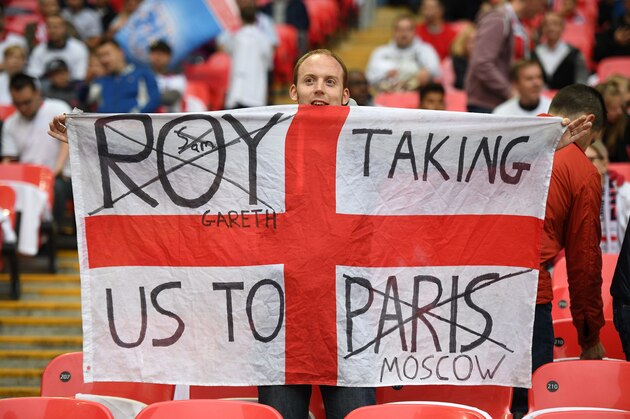 An England supporter holds up a re-used flag ahead of the World Cup 2018 football qualification match between England and Malta at Wembley Stadium in London on October 8, 2016.  / AFP / Justin TALLIS / NOT FOR MARKETING OR ADVERTISING USE / RESTRICTED TO EDITORIAL USE        (Photo credit should read JUSTIN TALLIS/AFP/Getty Images)