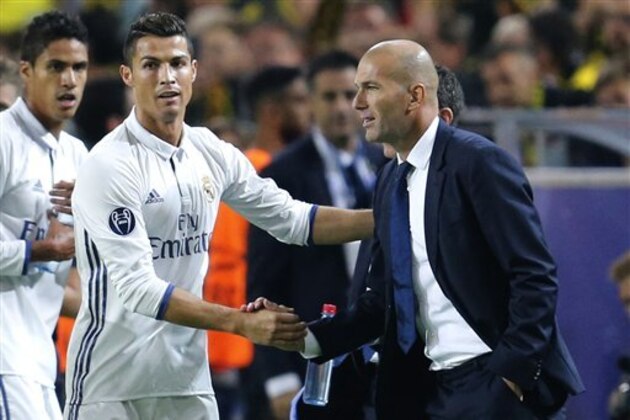 Real Madrid's Cristiano Ronaldo celebrates scoring the opening goal with Real Madrid's head coach Zinedine Zidane during the Champions League group F soccer match between Borussia Dortmund and Real Madrid in Dortmund, Germany, Tuesday, Sept. 27, 2016. (AP Photo/Michael Probst)