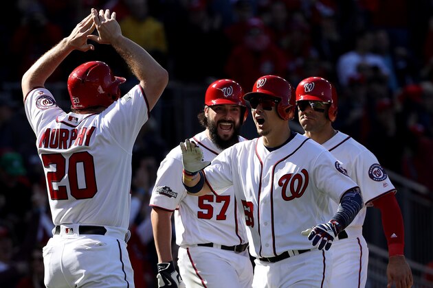 WASHINGTON, DC - OCTOBER 9: Jose Lobaton #59 of the Washington Nationals celebrates with teammates Danny Espinosa #8, Tanner Roark #57, and Daniel Murphy #20 after hitting a three run home run against the Los Angeles Dodgers in the fourth inning during game two of the National League Division Series at Nationals Park on October 9, 2016 in Washington, DC. (Photo by Patrick Smith/Getty Images)