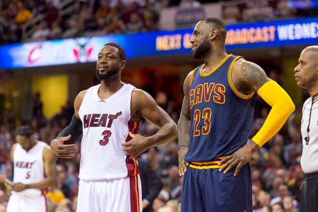 CLEVELAND, OH - APRIL 2: Dwyane Wade #3 of the Miami Heat talks with LeBron James #23 of the Cleveland Cavaliers during the first half at Quicken Loans Arena on April 2, 2015 in Cleveland, Ohio. NOTE TO USER: User expressly acknowledges and agrees that, by downloading and or using this photograph, User is consenting to the terms and conditions of the Getty Images License Agreement. (Photo by Jason Miller/Getty Images)