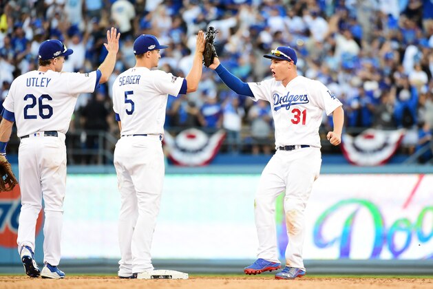 LOS ANGELES, CA - OCTOBER 11:  Joc Pederson #31 of the Los Angeles Dodgers celebrates with Chase Utley #26 and Corey Seager #5 after their 6 to 5 victory over the Washington Nationals during game four of the National League Division Series at Dodger Stadium on October 11, 2016 in Los Angeles, California.  (Photo by Harry How/Getty Images)