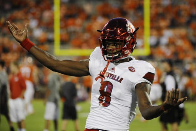 FILE - In this Oct. 1, 2016, file photo, Louisville quarterback Lamar Jackson warms up before their NCAA college football game against Clemson, in Clemson, S.C. The challenge for Lamar Jackson as he chases the Heisman Trophy is to maintain front-runner status while playing games that will not be drawing a lot of attention. (AP Photo/Rainier Ehrhardt, File)