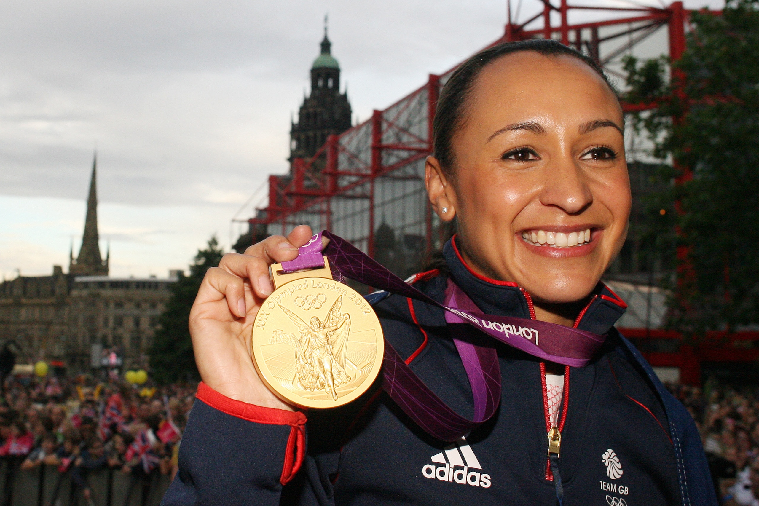 British athlete Jessica Ennis holds her Olympic gold medal as she arrives for a homecoming party at the Sheffield Town Hall in Sheffield, on August 17, 2012. Locally-born Ennis won gold medal in the Women's Heptathlon race in the London 2012 Olympics. Thousands of fans lined the city centre streets to see the Team GB athlete on stage with her gold medal. AFP PHOTO / Lindsey Parnaby        (Photo credit should read LINDSEY PARNABY/AFP/GettyImages)