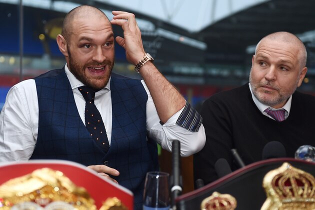 Britain's world heavyweight champion Tyson Fury (L) takes part in a press conference with his uncle and trainer Peter Fury in Bolton, north west England on November 30, 2015. Tyson Fury was crowned the new world heavyweight champion on November 28, ending Wladimir Klitschko's nine-year reign as champion in 12 rounds.
AFP PHOTO/PAUL ELLIS / AFP / PAUL ELLIS        (Photo credit should read PAUL ELLIS/AFP/Getty Images)