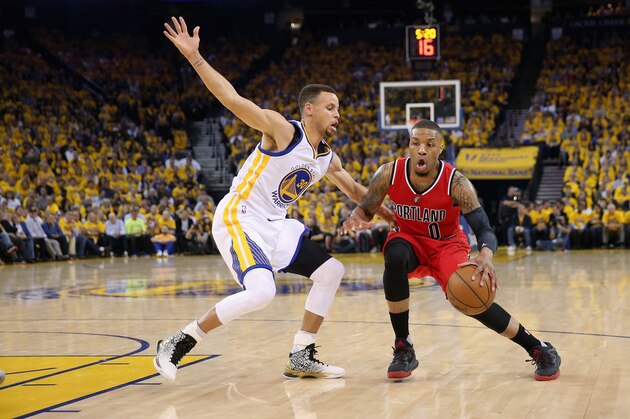 OAKLAND, CA - MAY 11:  Damian Lillard #0 of the Portland Trail Blazers is guarded by Stephen Curry #30 of the Golden State Warriors during Game Five of the Western Conference Semifinals during the 2016 NBA Playoffs on May 11, 2016 at Oracle Arena in Oakland, California.  NOTE TO USER: User expressly acknowledges and agrees that, by downloading and or using this photograph, User is consenting to the terms and conditions of the Getty Images License Agreement.  (Photo by Ezra Shaw/Getty Images)