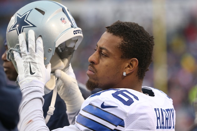 ORCHARD PARK, NY - DECEMBER 27: Greg Hardy #76 of the Dallas Cowboys puts on his helmet on the sideline against the Buffalo Bills during NFL game action at Ralph Wilson Stadium on December 27, 2015 in Orchard Park, New York. (Photo by Tom Szczerbowski/Getty Images)