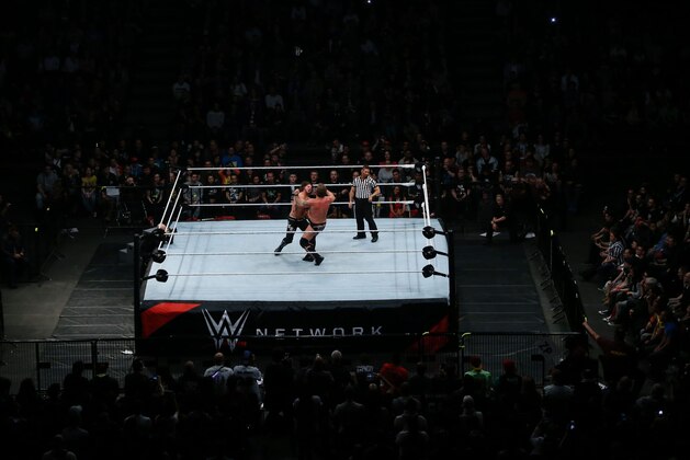 Wrestlers fight during a show at the AccorHotels Arena in Paris, as part of the WrestleMania Revenge Tour, the World Wrestling Entertainment (WWE) European tour, on April 22, 2016.  / AFP / THOMAS SAMSON        (Photo credit should read THOMAS SAMSON/AFP/Getty Images)