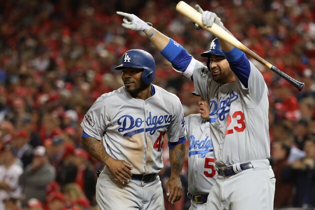 WASHINGTON, DC - OCTOBER 13: Howie Kendrick #47 and Adrian Gonzalez #23 of the Los Angeles Dodgers celebrate after teammate Justin Turner #10 hit a two run RBI triple in the seventh inning against the Washington Nationals during game five of the National League Division Series at Nationals Park on October 13, 2016 in Washington, DC. (Photo by Rob Carr/Getty Images)