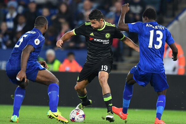 Chelsea's Brazilian-born Spanish striker Diego Costa (C) vies with Leicester City's English-born Jamaican defender Wes Morgan and Leicester City's Ghanaian midfielder Daniel Amartey (R) during extra time in the English League Cup third round football match between Leicester City and Chelsea at King Power Stadium in Leicester, central England on September 20, 2016. Chelsea won the game 4-2 after extra time.  / AFP / ANTHONY DEVLIN / RESTRICTED TO EDITORIAL USE. No use with unauthorized audio, video, data, fixture lists, club/league logos or 'live' services. Online in-match use limited to 75 images, no video emulation. No use in betting, games or single club/league/player publications.  /         (Photo credit should read ANTHONY DEVLIN/AFP/Getty Images)