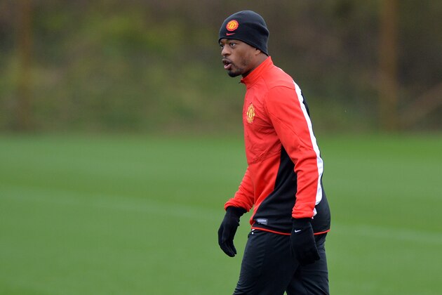 Manchester United's French defender Patrice Evra takes part in a training session at their Carrington complex in Manchester, north west England, on February  24, 2014 ahead of the UEFA Champions League football match between Olympiakos and Manchester United on February 25. AFP PHOTO / PAUL ELLIS        (Photo credit should read PAUL ELLIS/AFP/Getty Images)