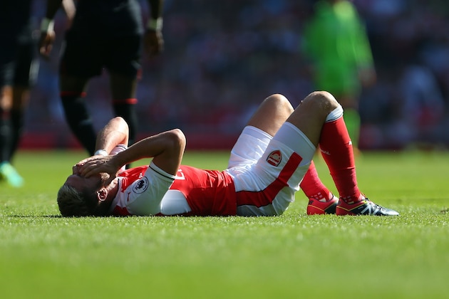 LONDON, ENGLAND - AUGUST 14: An injured Aaron Ramsey of Arsenal during the Premier League match between Arsenal and Liverpool at Emirates Stadium on August 14, 2016 in London, England. (Photo by Catherine Ivill - AMA/Getty Images)