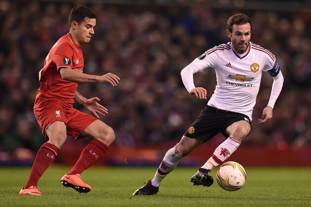 Liverpool's Brazilian midfielder Philippe Coutinho (L) vies Manchester United's Spanish midfielder Juan Mata with during the UEFA Europa League round of 16, first leg football match between Liverpool and Manchester United at Anfield in Liverpool, northwest England on March 10, 2016. / AFP / PAUL ELLIS        (Photo credit should read PAUL ELLIS/AFP/Getty Images)