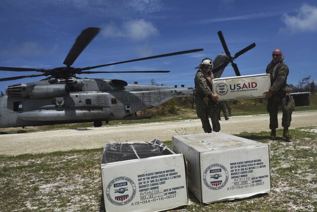 Aid is unloaded from a US helicopter in Jeremie, southwest of Port-au-Prince, Haiti, on October 10, 2016 following the passage of Hurricane Matthew.
Haiti's death toll from monster Hurricane Matthew has risen to 372, civil defense officials said Monday, as the impoverished country continues to dig out of massive destruction in the south. More than 175,500 people were staying in temporary shelters, days after the Caribbean's worst storm in nearly a decade slammed into Haiti last Tuesday.
 / AFP / Rodrigo ARANGUA        (Photo credit should read RODRIGO ARANGUA/AFP/Getty Images)