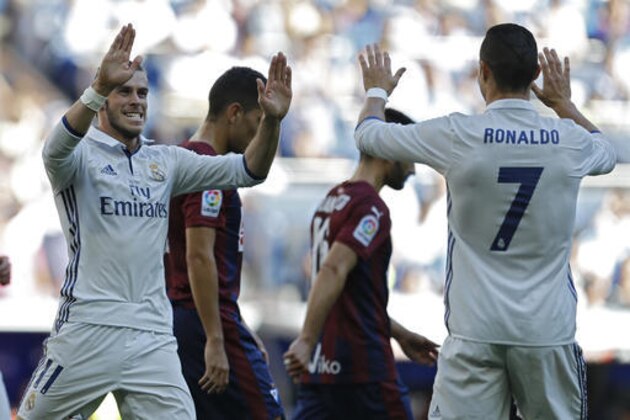 Real Madrid's Gareth Bale, left, celebrates with teammate Cristiano Ronaldo after scoring their side's first goal against Eibar during the Spanish La Liga soccer match between Real Madrid and Eibar at the Santiago Bernabeu stadium in Madrid, Sunday, Oct. 2, 2016. (AP Photo/Francisco Seco)