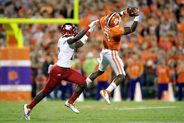 CLEMSON, SC - OCTOBER 01: Artavis Scott #3 of the Clemson Tigers makes the catch under pressure from Chucky Williams #22 of the Louisville Cardinals during the second quarter at Memorial Stadium on October 1, 2016 in Clemson, South Carolina.  (Photo by Tyler Smith/Getty Images)