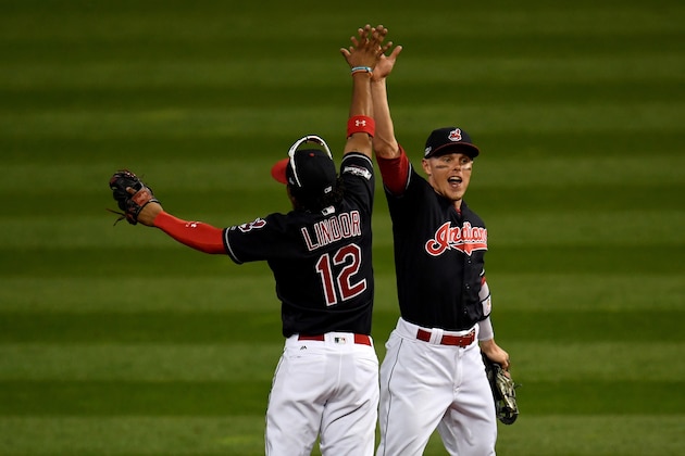 CLEVELAND, OH - OCTOBER 15:  Francisco Lindor #12 and Brandon Guyer #6 of the Cleveland Indians celebrate after defeating the Toronto Blue Jays with a score of 2 to 1 in game two of the American League Championship Series at Progressive Field on October 15, 2016 in Cleveland, Ohio.  (Photo by Jason Miller/Getty Images)