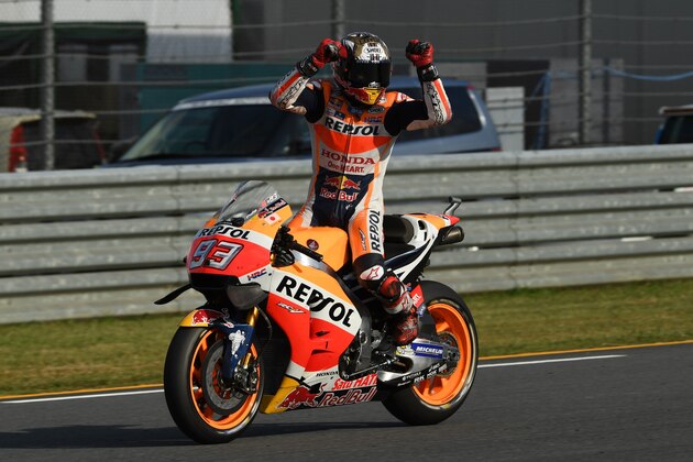 Repsol Honda Team's Spanish rider Marc Marquez celebrates his win at the MotoGP Japanese Grand Prix and for securing his third world championship title at the Twin Ring Motegi circuit in Motegi on October 16, 2016. 
Marc Marquez secured his third world championship by winning the Japan Grand Prix Sunday where his closest rivals Yamaha duo Valentino Rossi and Jorge Lorenzo both crashed out. / AFP / Toshifumi KITAMURA        (Photo credit should read TOSHIFUMI KITAMURA/AFP/Getty Images)