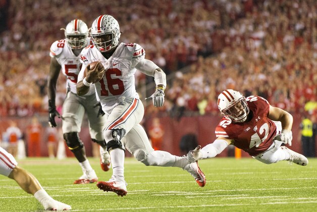 Oct 15, 2016; Madison, WI, USA;  Ohio State Buckeyes quarterback J.T. Barrett (16) rushes with the football as Wisconsin Badgers linebacker T.J. Watt (42) dives from behind during the fourth quarter at Camp Randall Stadium.  Ohio State won 30-23.  Mandatory Credit: Jeff Hanisch-USA TODAY Sports