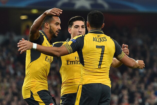 Arsenal's English midfielder Theo Walcott (L) celebrates with Arsenal's Chilean striker Alexis Sanchez (R) and Arsenal's Spanish defender Hector Bellerin after scoring the opening goal of the UEFA Champions League Group A football match between Arsenal and FC Basel at The Emirates Stadium in London on September 28, 2016. / AFP / IKIMAGES / Glyn KIRK        (Photo credit should read GLYN KIRK/AFP/Getty Images)
