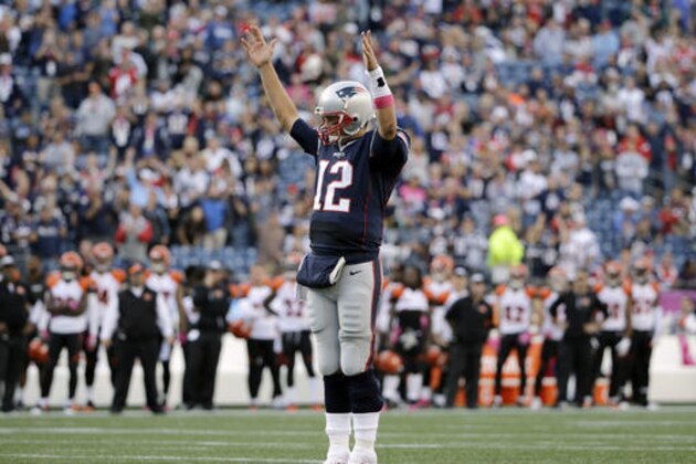 New England Patriots quarterback Tom Brady signals touchdown as running back LeGarrette Blount scores during the second half of an NFL football game against the Cincinnati Bengals, Sunday, Oct. 16, 2016, in Foxborough, Mass. (AP Photo/Elise Amendola)