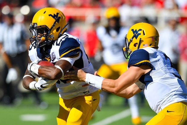 LUBBOCK, TX - OCTOBER 15: Skyler Howard #3 of the West Virginia Mountaineers hands the ball off to Justin Crawford #25 of the West Virginia Mountaineers during the game on October 15, 2016 at AT&T Jones Stadium in Lubbock, Texas. (Photo by John Weast/Getty Images)
