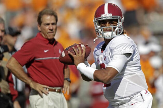 Alabama quarterback Jalen Hurts (2) warms up before an NCAA college football game against Tennessee as Alabama head coach Nick Saban watches Saturday, Oct. 15, 2016, in Knoxville, Tenn. (AP Photo/Wade Payne)