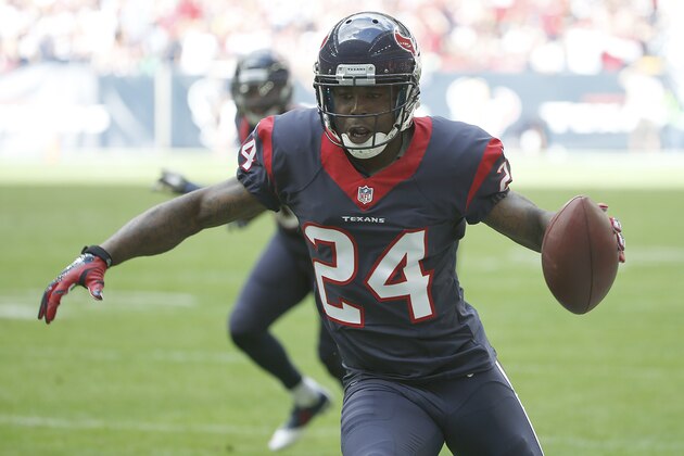 HOUSTON, TX - NOVEMBER 30: Johnathan Joseph #24 of the Houston Texans runs after intercepting the ball against  the Tennessee Titans in the first quarter in a NFL game on November 30, 2014 at NRG Stadium in Houston, Texas. (Photo by Scott Halleran/Getty Images)