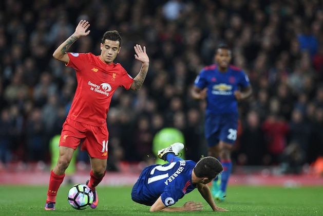 Liverpool's Brazilian midfielder Philippe Coutinho (L) vies with Manchester United's Spanish midfielder Ander Herrera during the English Premier League football match between Liverpool and Manchester United at Anfield in Liverpool, north west England on October 17, 2016. / AFP / Paul ELLIS / RESTRICTED TO EDITORIAL USE. No use with unauthorized audio, video, data, fixture lists, club/league logos or 'live' services. Online in-match use limited to 75 images, no video emulation. No use in betting, games or single club/league/player publications.  /         (Photo credit should read PAUL ELLIS/AFP/Getty Images)