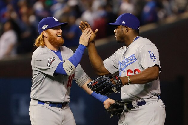 CHICAGO, IL - OCTOBER 16:  Justin Turner #10 and Yasiel Puig #66 of the Los Angeles Dodgers celebrate after defeating the Chicago Cubs 1-0 in game two of the National League Championship Series at Wrigley Field on October 16, 2016 in Chicago, Illinois.  (Photo by Jamie Squire/Getty Images)