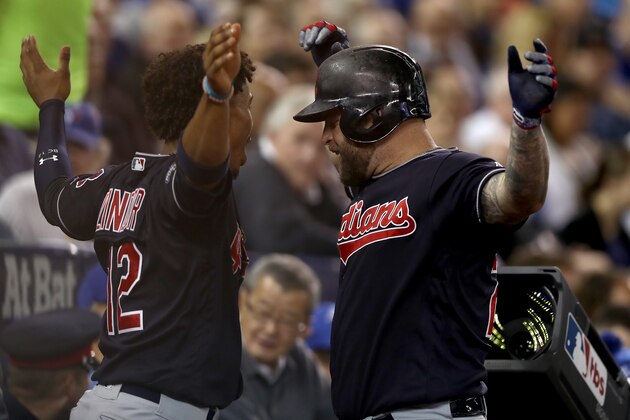 TORONTO, ON - OCTOBER 17:  Mike Napoli #26 of the Cleveland Indians celebrates with teammate Francisco Lindor #12 after hitting a solo home run in the fourth inning against Marcus Stroman #6 of the Toronto Blue Jays during game three of the American League Championship Series at Rogers Centre on October 17, 2016 in Toronto, Canada.  (Photo by Elsa/Getty Images)