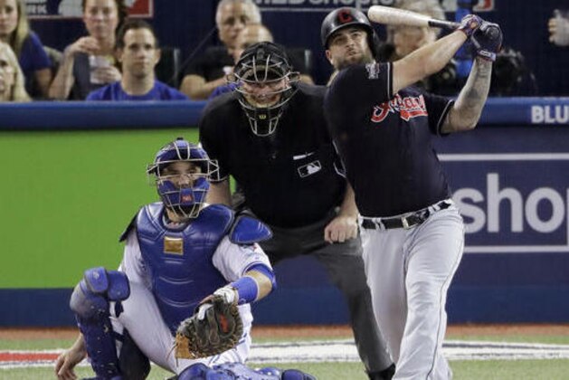Cleveland Indians' Mike Napoli, right, watches his home during the fourth inning in Game 3 of baseball's American League Championship Series against the Toronto Blue Jays in Toronto, Monday, Oct. 17, 2016. (AP Photo/Charlie Riedel)
