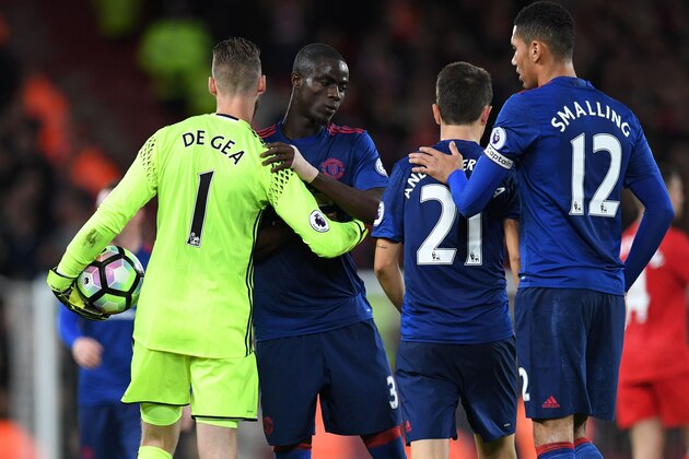 Manchester United's Spanish goalkeeper David de Gea (L) is thanked by Manchester United's Ivorian defender Eric Bailly after the English Premier League football match between Liverpool and Manchester United at Anfield in Liverpool, north west England on October 17, 2016.
Arch rivals Liverpool and Manchester United failed to spark as England's two most successful clubs played out a forgettable 0-0 draw in the Premier League on Monday. / AFP / Paul ELLIS / RESTRICTED TO EDITORIAL USE. No use with unauthorized audio, video, data, fixture lists, club/league logos or 'live' services. Online in-match use limited to 75 images, no video emulation. No use in betting, games or single club/league/player publications.  /         (Photo credit should read PAUL ELLIS/AFP/Getty Images)
