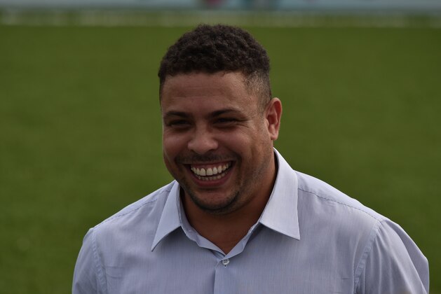 Brazilian former footballer and member of the FIFA LOC Ronaldo smiles during the opening ceremony for the Football for Hope Festival 2014 at the Vila Olimpica Mane Garrincha in Rio de Janeiro on July 7, 2014. The Football for Hope Festival 2014 brings 32 teams from around the world that struggle against social issues through football and is played by players of mixed gender without referees until July 10, 2014.  AFP PHOTO / YASUYOSHI CHIBA        (Photo credit should read YASUYOSHI CHIBA/AFP/Getty Images)