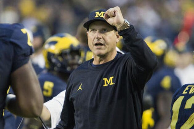FILE - In this Oct. 1, 2016, file photo, Michigan head coach Jim Harbaugh cheers on his players after a Michigan touchdown in the fourth quarter of an NCAA college football game against Wisconsin at Michigan Stadium in Ann Arbor, Mich. Clearly, No. 2 Ohio State and No. 4 Michigan have been the class of the Big Ten so far. No. 8 Wisconsin and No. 10 Nebraska, though, will get a chance to prove the conference isn't the Big Two and Little Eight like it used to be years ago with the Buckeyes and Wolverines playing on another level.  (AP Photo/Tony Ding, File)