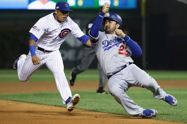 CHICAGO, IL - OCTOBER 16:  Addison Russell #27 of the Chicago Cubs chases Adrian Gonzalez #23 of the Los Angeles Dodgers in the sixth inning before tagging him out to complete the double play during game two of the National League Championship Series at Wrigley Field on October 16, 2016 in Chicago, Illinois.  (Photo by Jonathan Daniel/Getty Images)