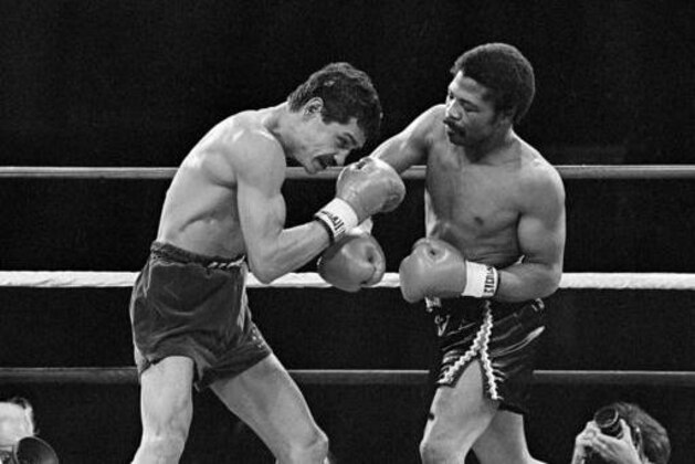FILE - In this Nov. 12, 1982, file photo, Alexis Arguello covers up as defending champ Aaron Pryor throws a hard right during the second round of boxing action at the Orange Bowl in Miami. Pryor, the relentless junior welterweight died Sunday, Oct. 9, 2016, at the age of 60. Pryor's family issued a statement saying the former boxer died at his home in Cincinnati after a long battle with heart disease. (AP Photo/File)