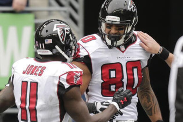 Atlanta Falcons wide receiver Julio Jones (11) celebrates with tight end Levine Toilolo (80) after Toilolo caught a pass for a touchdown in the second half of an NFL football game, Sunday, Oct. 16, 2016, in Seattle. (AP Photo/Stephen Brashear)