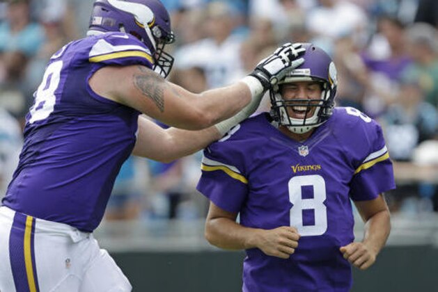 ADVANCE FOR WEEKEND EDITIONS, OCT. 15-16 - FILE - In this Sept. 25, 2016, file photo, Minnesota Vikings' Sam Bradford (8) is congratulated by Jeremiah Sirles (78) after touchdown pass against the Carolina Panthers in the second half of an NFL football game in Charlotte, N.C. The Vikings have been so far able to endure a slew of injuries to important players that many other teams wouldn't, with a well-constructed roster of players exemplifying coach Mike Zimmer's defiant personality. They're the only undefeated team left in the NFL entering their bye week. (AP Photo/Bob Leverone, File)