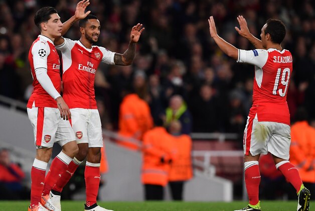 Arsenal's English midfielder Theo Walcott (C) celebrates scoring his team's second goal with Arsenal's Spanish defender Hector Bellerin (L) and Arsenal's Spanish midfielder Santi Cazorla during the UEFA Champions League Group A football match between Arsenal and Ludogorets Razgrad at The Emirates Stadium in London on October 19, 2016. / AFP / BEN STANSALL        (Photo credit should read BEN STANSALL/AFP/Getty Images)
