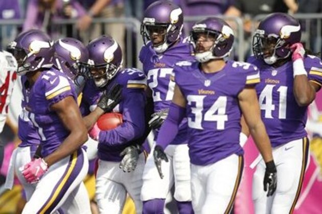 Minnesota Vikings cornerback Marcus Sherels, center, celebrates with teammates after returning a punt 79-yards for a touchdown during the first half of an NFL football game against the Houston Texans Sunday, Oct. 9, 2016, in Minneapolis. (AP Photo/Andy Clayton-King)