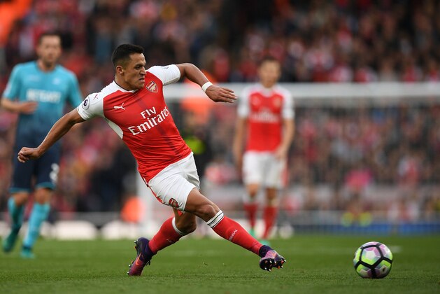 Arsenal's Chilean striker Alexis Sanchez passes the ball during the English Premier League football match between Arsenal and Swansea City at the Emirates Stadium in London on October 15, 2016. 
Arsenal won the game 3-2. / AFP / Justin TALLIS / RESTRICTED TO EDITORIAL USE. No use with unauthorized audio, video, data, fixture lists, club/league logos or 'live' services. Online in-match use limited to 75 images, no video emulation. No use in betting, games or single club/league/player publications.  /         (Photo credit should read JUSTIN TALLIS/AFP/Getty Images)